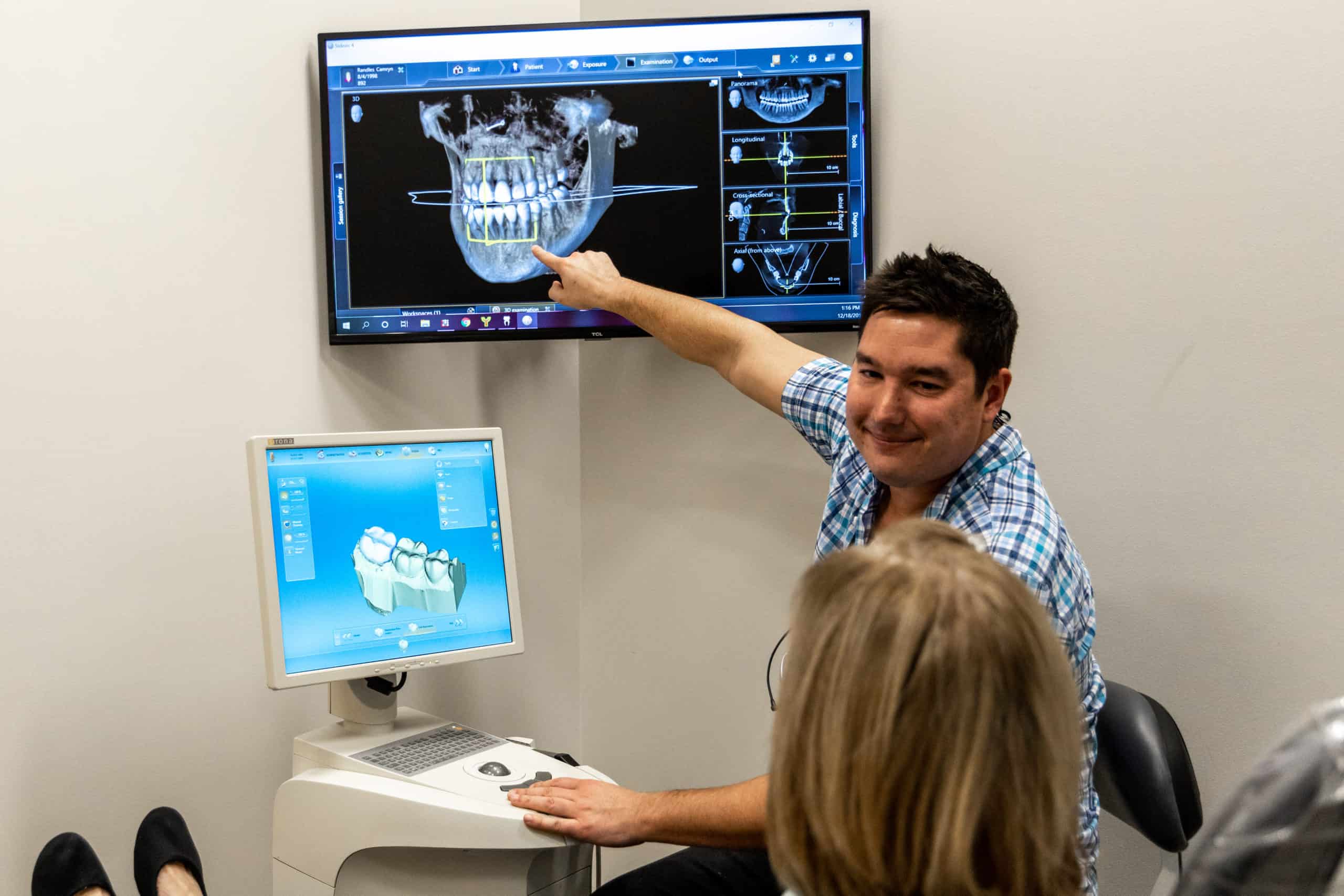 Dentist showing a patient a 3d scan