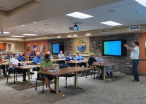 A group of people implementing cybersecurity tips in a conference room.