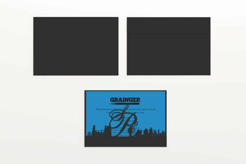 A printed black envelope with a blue background and a black square.