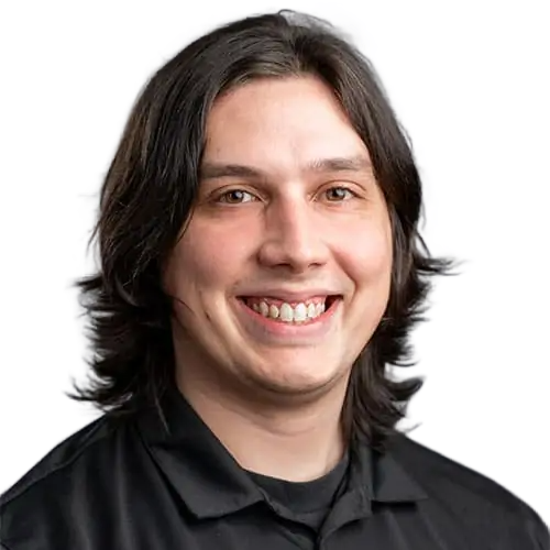 Anthony A smiling man with long hair wearing a black shirt.