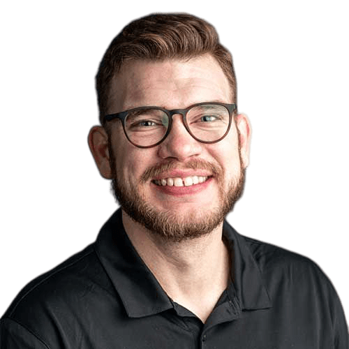 Dustin-transformed An IT expert with glasses smiling in a black shirt.