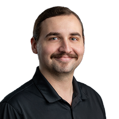 An IT expert man in a black shirt with a mustache who manages and maintains your network and IT investments.