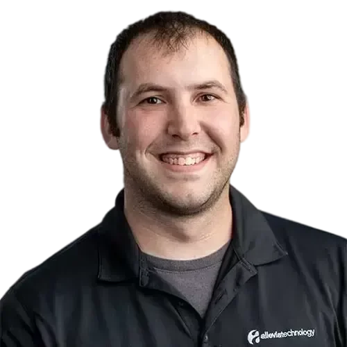 A man smiling in a black shirt, representing IT expertise.