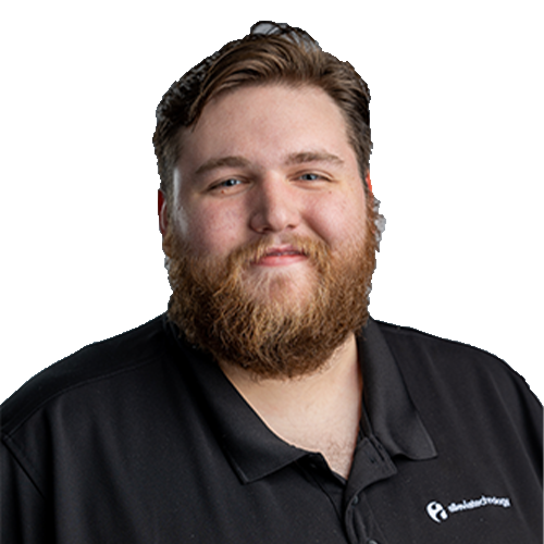 KaceyM_CutOut An IT expert with a beard wearing a black polo shirt.