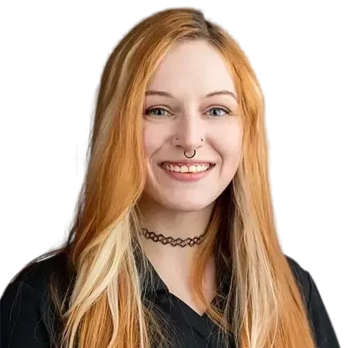 A woman with long red hair smiling in front of a black background while IT experts manage and maintain your network.