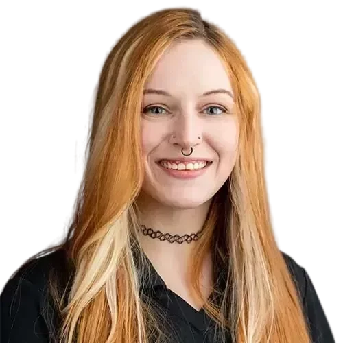 RaeW-transformed A woman with long red hair smiling in front of a black background while IT experts manage and maintain your network.