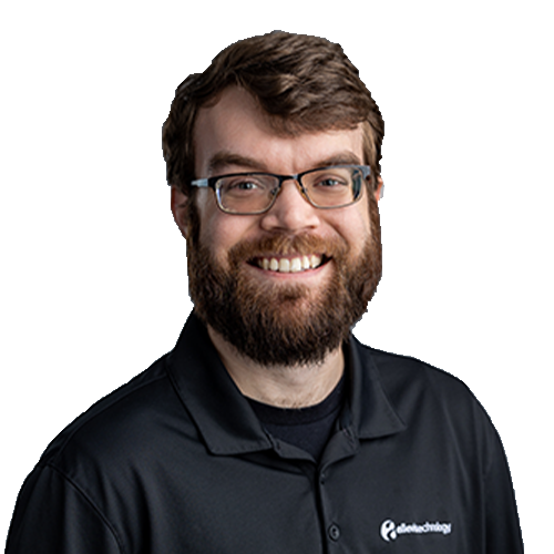 SamuelV_CutOut A bearded man is smiling as an IT expert.