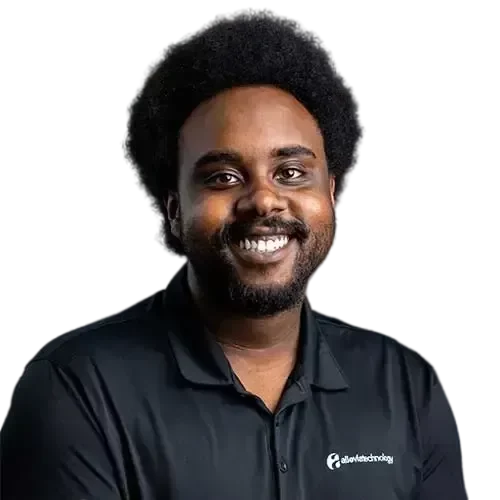 A black IT expert smiling in a black polo shirt.