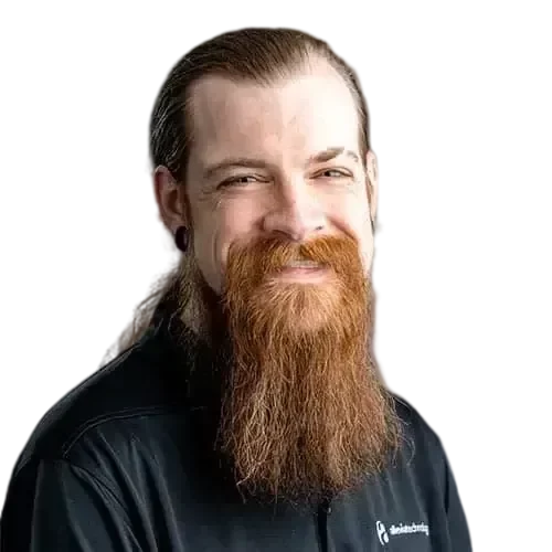 Thomas-transformed A bearded man in a black shirt who manages and maintains IT networks and investments.
