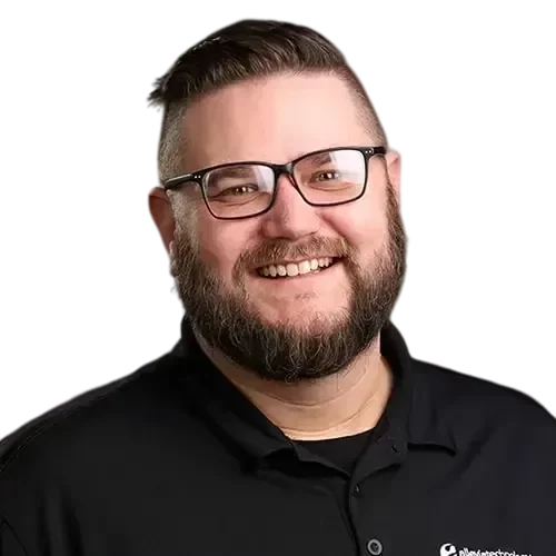 An IT expert with glasses and a beard smiling for the camera.