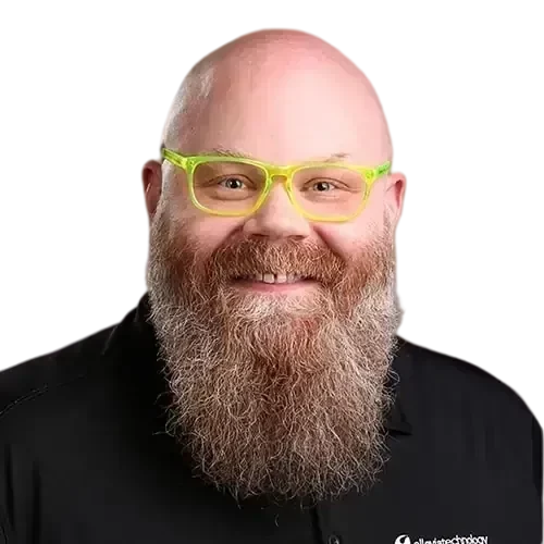 An IT expert with a beard and glasses who manages and maintains networks and IT investments.