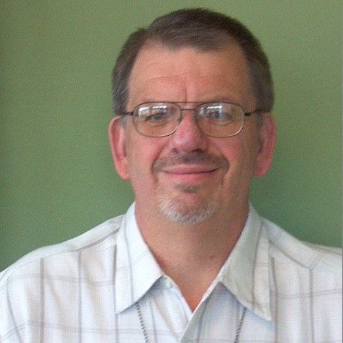 pastor mike A man wearing glasses and a plaid shirt.